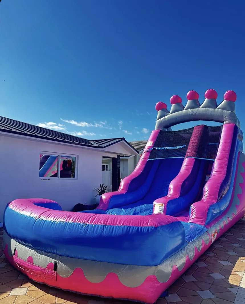 The Pink Crown Slide inflated in front of a home